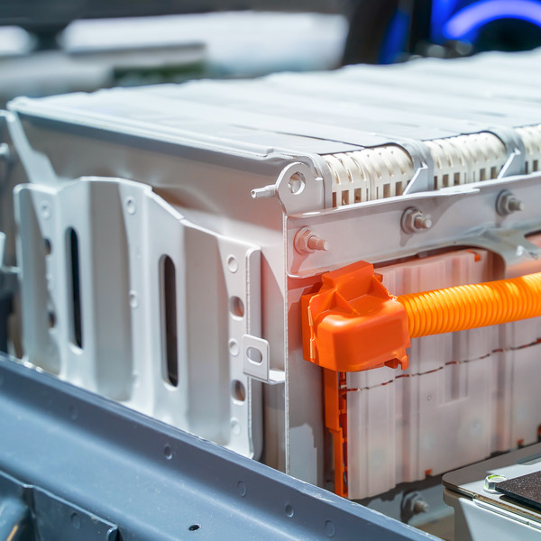 close-up of a large lithium-ion battery pack in an electric vehicle with an orange cable close-up of a large lithium-ion battery pack in an electric vehicle with an orange cable
